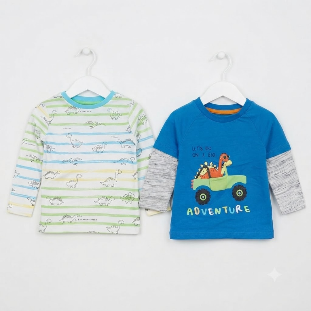 Two children's long-sleeve shirts hanging on white hangers against a plain white background. The left shirt has light green and white horizontal stripes with a dinosaur print and a light blue collar.