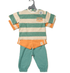 Children's outfit with striped shirt, orange shorts, and green pants on a hanger.