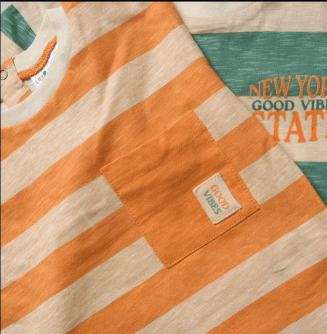 Close-up of an orange and beige striped shirt with a visible brand tag.