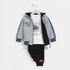 A children's three-piece clothing set displayed on a hanger against a plain white background. The set includes a light gray zip-up hoodie with black trim and 'ACTIVE' text, a white graphic t-shirt, and black jogger pants.