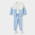 A children's color-blocked two-piece tracksuit set featuring a light blue and off-white jacket with a white collar, paired with matching light blue jogger pants with white side stripes, styled with a white t-shirt and white sneakers on a light gray background.
