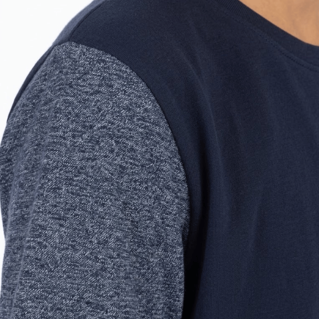 Navy blue long-sleeve shirt with textured gray sleeves on a plain background