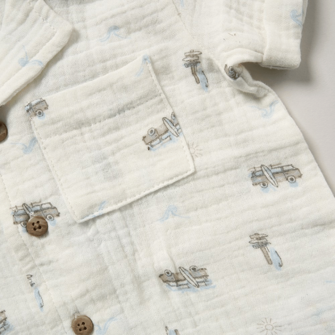 Close-up of a quilted fabric with airplane patterns and buttons.