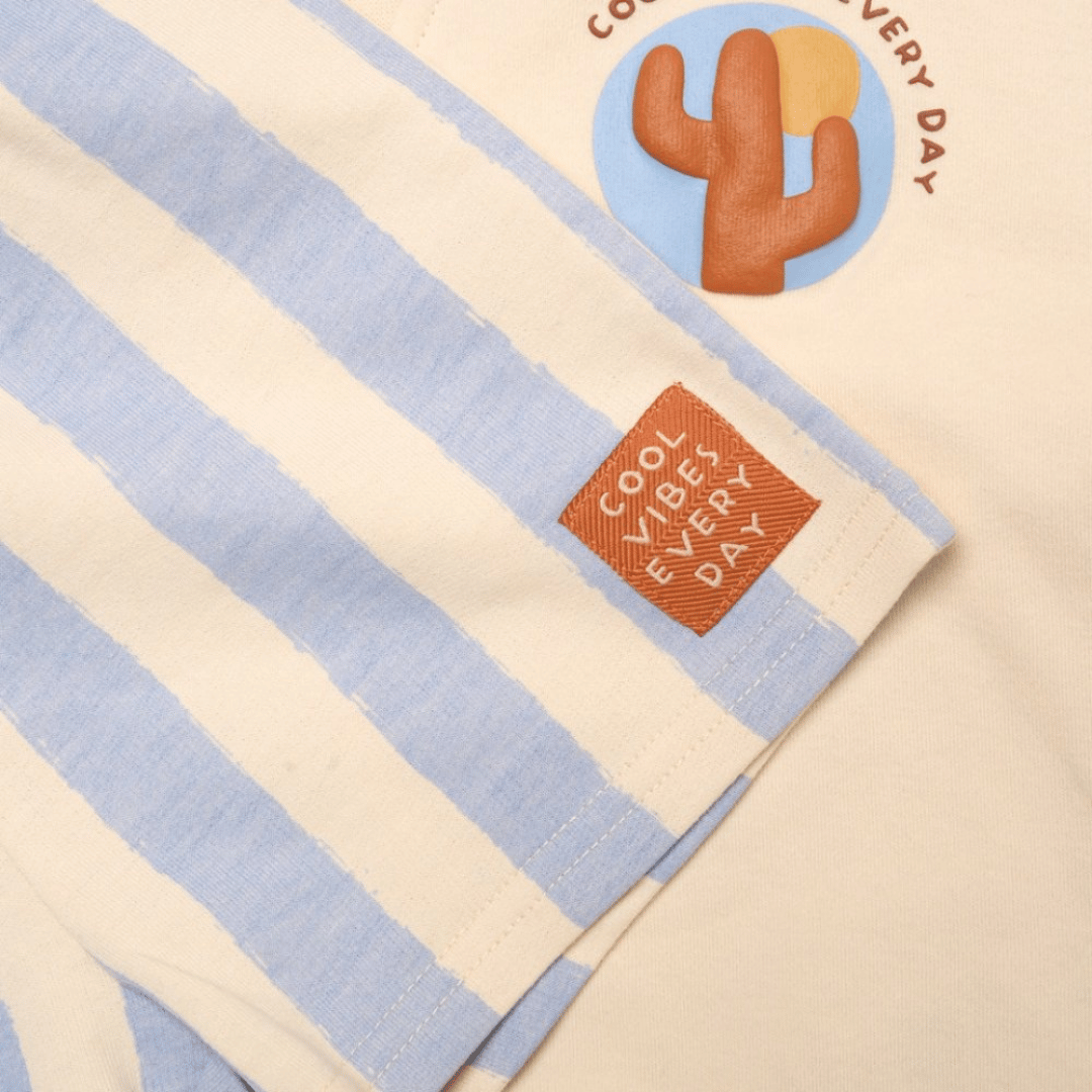 Striped towel with cactus design and 'Cool Vibes Every Day' text on a beige background