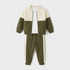 A children's two-piece colorblock tracksuit set featuring a cropped zip-up jacket and matching jogger pants. The jacket has a cream upper section and sleeves, with an olive green lower section and sleeves.