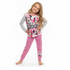 Young girl wearing a Minnie Mouse pajama set on a white background