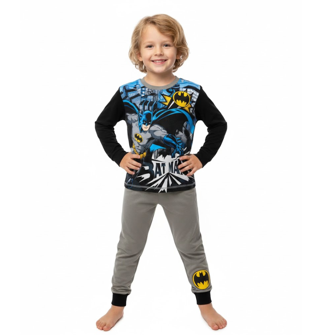 Child wearing Batman-themed pajamas on a white background