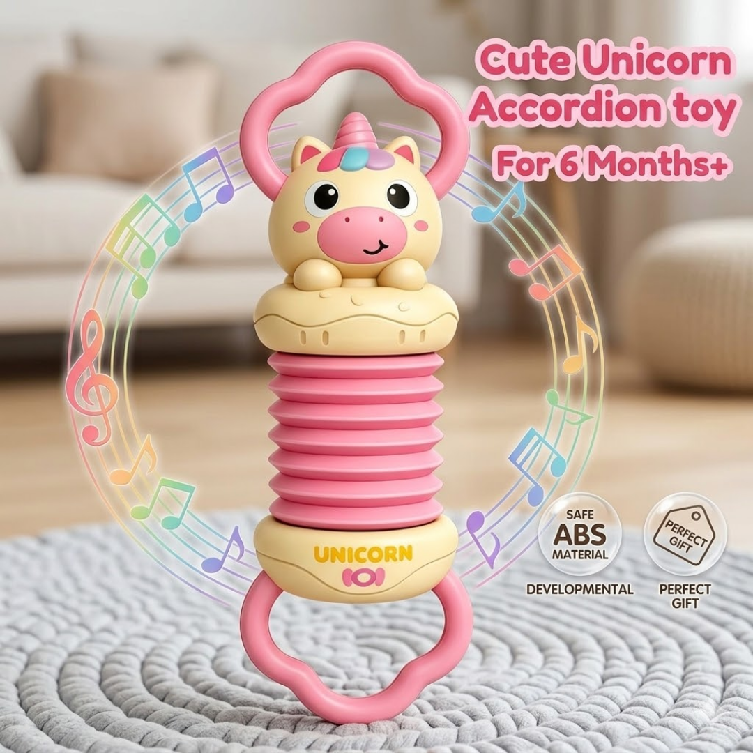 Pink unicorn accordion toy for babies on a textured surface with a blurred background