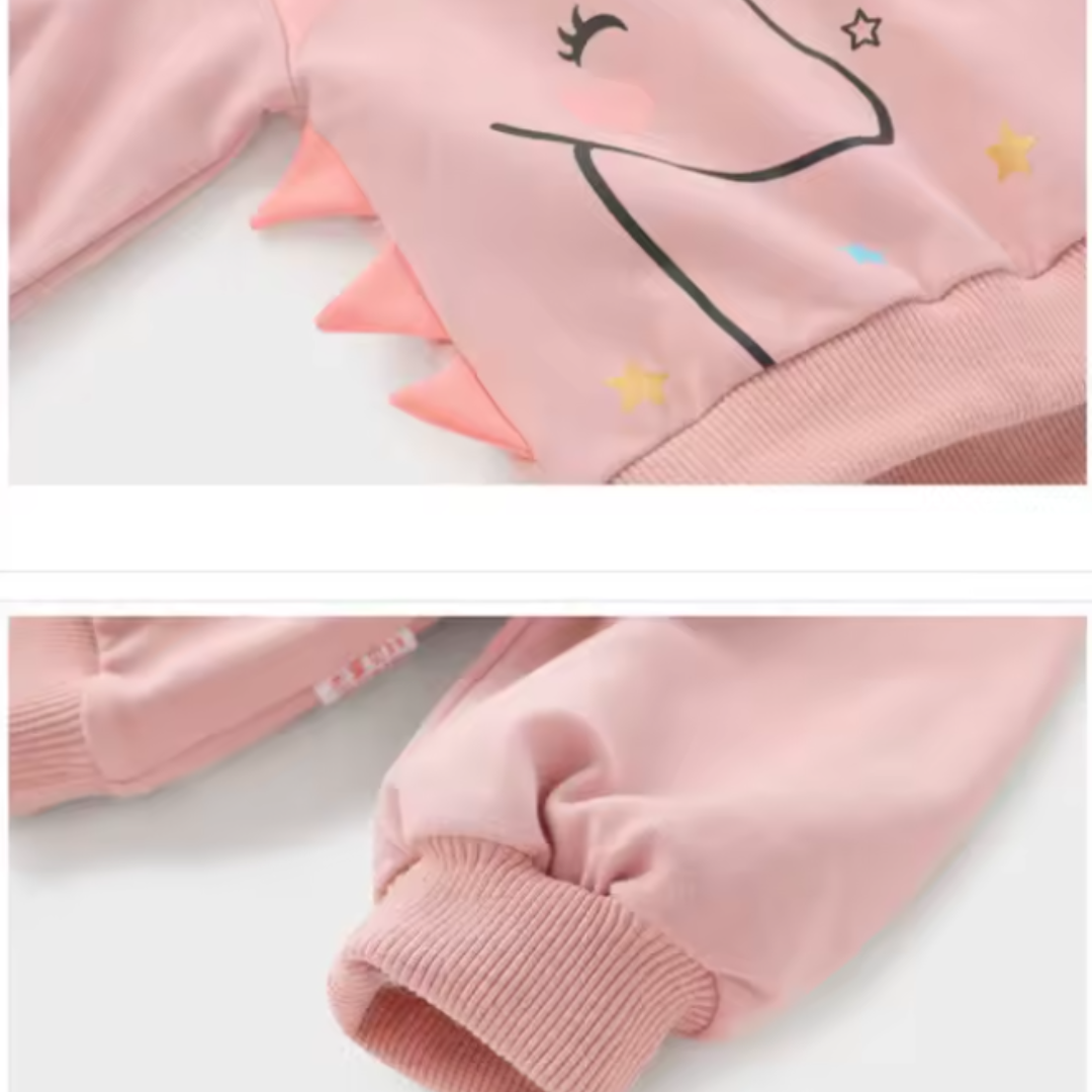 Close-up detail shots of a children's pink sweatshirt, showing a unicorn face graphic, dinosaur-style shoulder spikes, and ribbed cuffs.