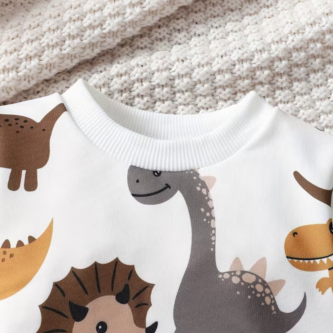 Children's sweater with dinosaur pattern on a textured fabric background