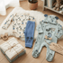 Baby clothing set with Mickey Mouse design on a wooden floor.