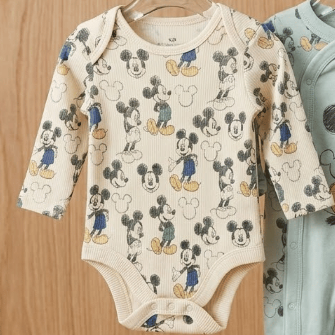 Baby Romper with Mickey Mouse design on wooden background