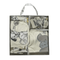 Set of baby clothing with cartoon designs in a box packaging.