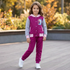 Young girl wearing a magenta and grey Disney Frozen tracksuit with a hooded button-front jacket and matching sweatpants, standing outdoors on a wooden deck.