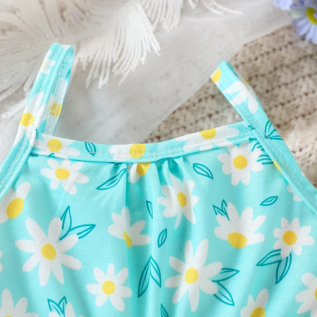 Light blue tank top with white daisy pattern on a textured surface