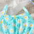 Light blue tank top with white daisy pattern on a textured surface