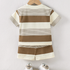 Children's striped shirt and shorts set on a hanger with white background