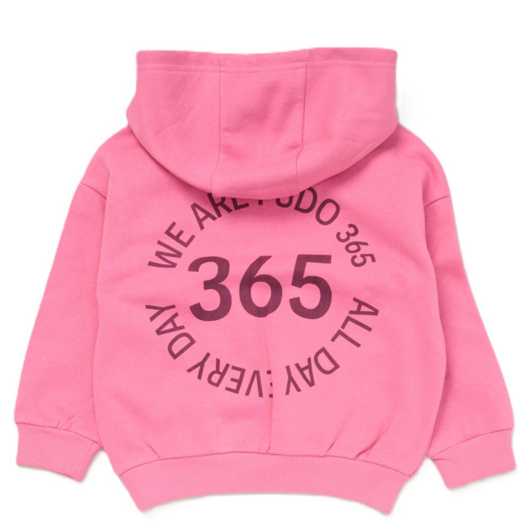 The back view of the pink hooded sweatshirt, featuring a large circular graphic text that reads 