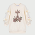 An off-white long-sleeve sweatshirt featuring a central Parisian-themed graphic of the Eiffel Tower adorned with a large bow and pink roses. The sleeves have sheer mesh sections with cream-colored ribbon bows at the cuffs.