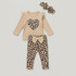 A baby girl's three-piece outfit set featuring a beige ribbed long-sleeve top with a leopard-print heart on the chest, matching leopard-print pants with a beige bow at the waist, and a matching leopard-print bow headband, all laid flat on a light gray background.