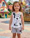 Child wearing a Minnie Mouse outfit in front of colorful playground equipment