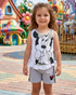 Child wearing a Minnie Mouse outfit in front of colorful playground equipment