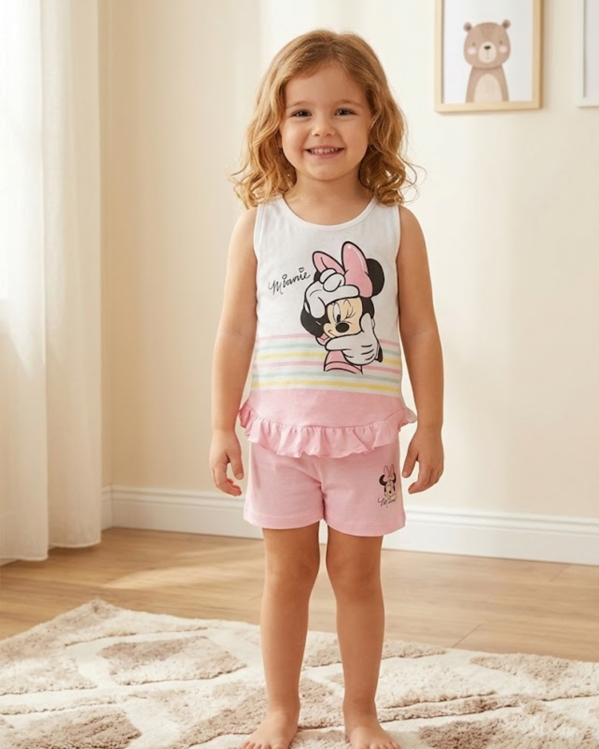 Young girl wearing a Minnie Mouse outfit in a room with light-colored walls and wooden floor.