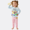 Child wearing a 'Baby Shark' themed pajama set on a white background