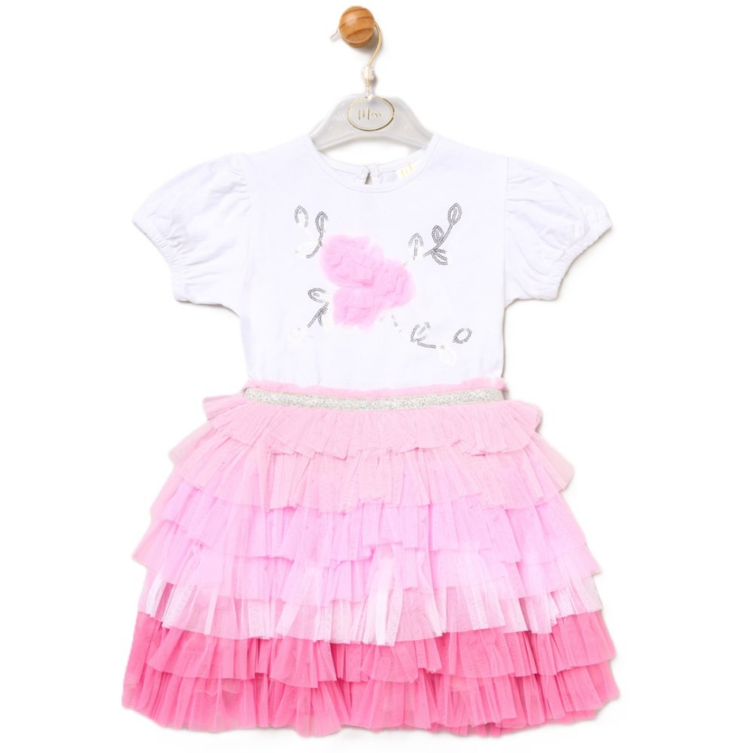 Children's outfit with white top and pink ruffled skirt on a hanger.