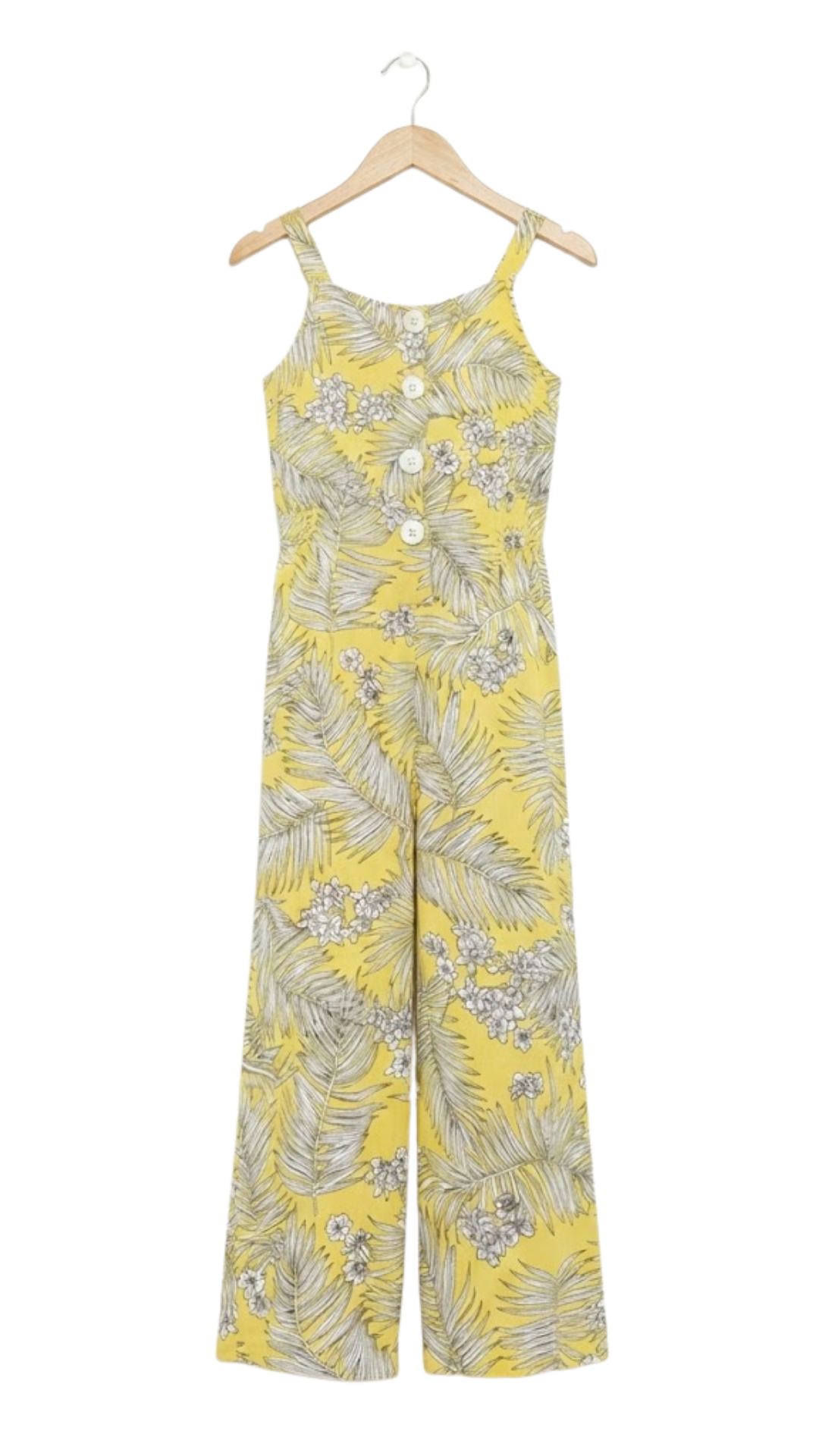 A yellow sleeveless jumpsuit with a gray palm leaf and white floral pattern, hanging on a wooden hanger against a white background.