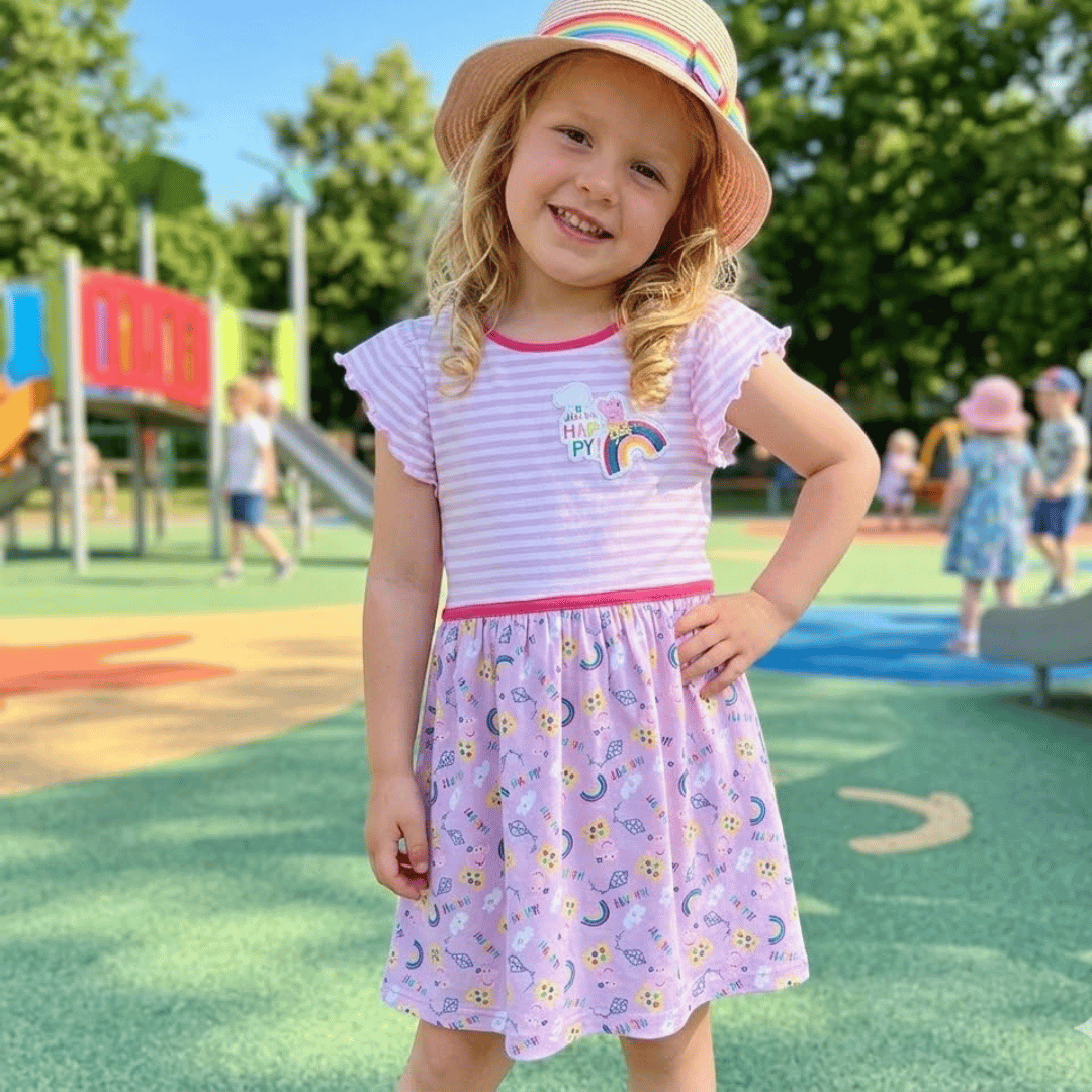 Girl wearing Pink cartoon Character Dress in a playground