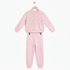A two-piece children's sweatshirt and jogger set in light pink, hanging on a wooden hanger against a plain white background. The sweatshirt features a textured knit pattern of hearts in various shades of pink, and the matching joggers have an elastic waistband with small black clips.