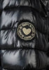 Black puffer jacket with a heart-shaped patch on a dark background