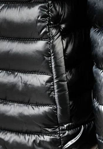 Close-up of a black puffer jacket with quilted texture