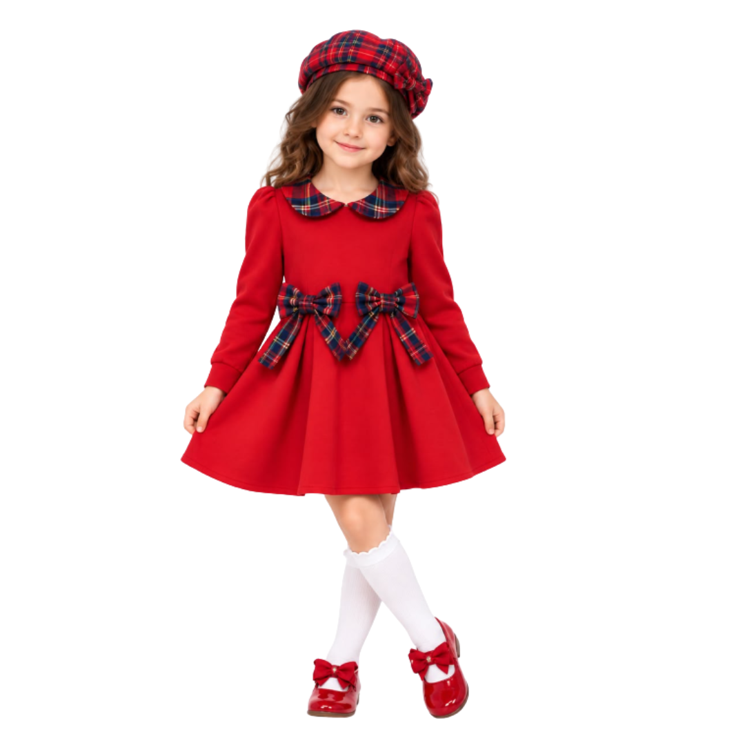 A young girl modeling a festive red dress costume with a red and blue plaid beret, matching plaid collar, waist bow, white knee-high socks, and red Mary Jane shoes, set against a plain white background.