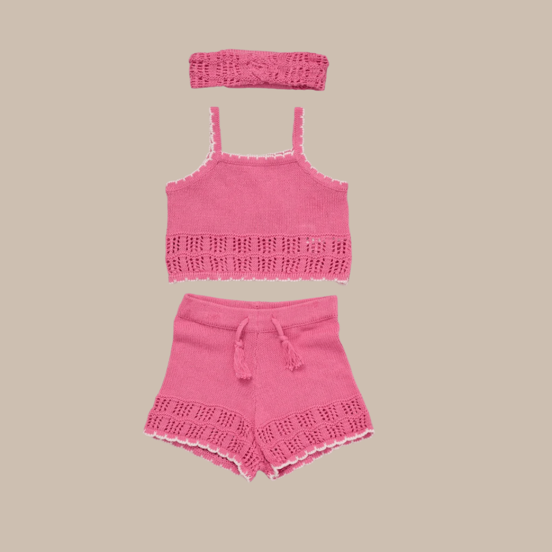 Pink crochet top and shorts set on a beige background
