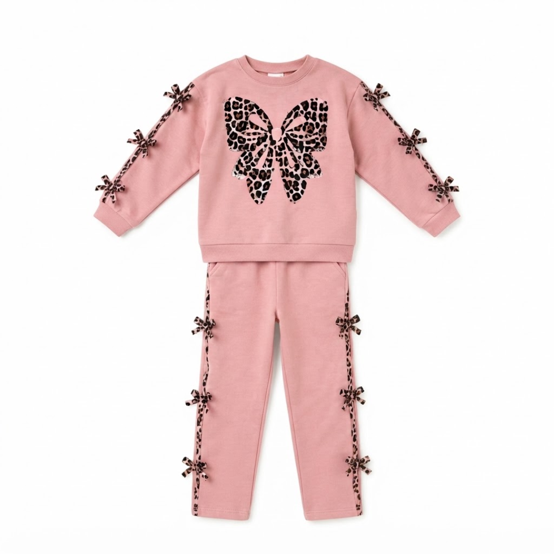 A two-piece kids' loungewear set in dusty pink, featuring a sweatshirt with a large black leopard-print butterfly graphic on the chest and matching pants with decorative butterfly embellishments along the side seams.