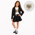 A young girl models a black denim jacket and pleated skirt set over a white graphic t-shirt with gold paint splatter details. A circular inset in the top right shows a close-up of the t-shirt's graphic print reading 'Shine Bright Love' in black script over gold paint strokes.