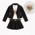 A girls' outfit set featuring a black moto jacket, pleated black mini skirt, and a white graphic t-shirt with a gold glittery 'Shine Bright Love' design. A circular inset shows the t-shirt design in detail.