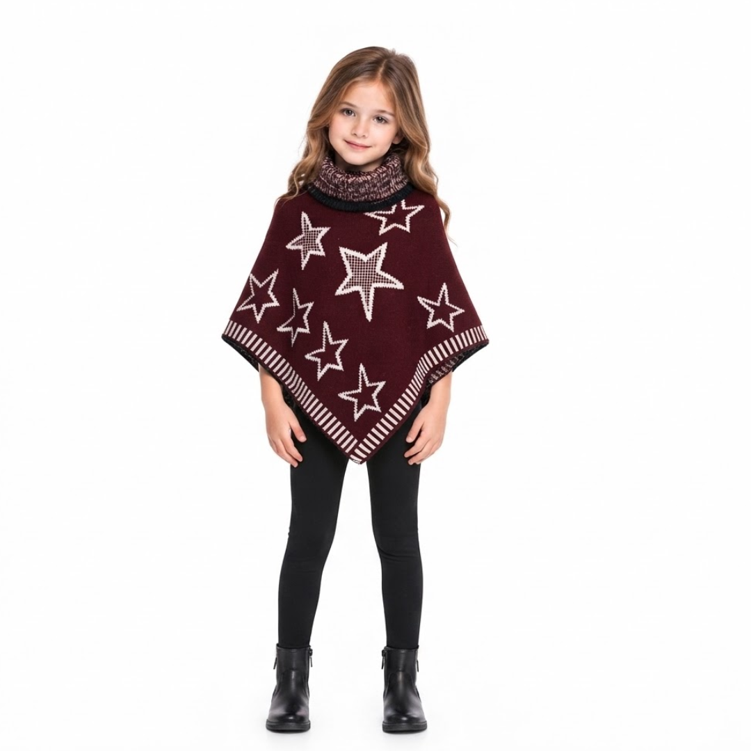A young girl modeling a burgundy knit poncho with white star patterns, paired with black leggings and black boots, against a solid white background.