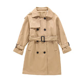 Beige trench coat with black buttons on a white background