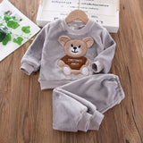Children's gray fleece set with bear design on a wooden surface
