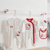 Hello Kitty baby clothing set on hangers against a white wall