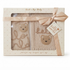 A boxed baby gift set from Rick a Bye Baby Boutique featuring a beige knit sweater and matching blanket with embroidered teddy bear faces and cursive text, presented in a cream gift box with a ribbon and tag.