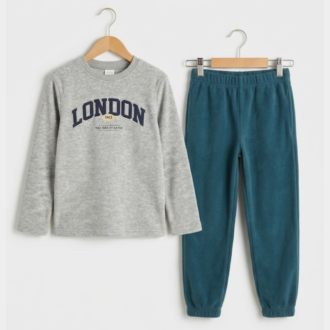 Gray sweatshirt with 'London' print and teal pants on hangers against a white background