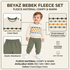 A toddler modeling a cream fleece sweater and sage green fleece pants set, shown on a beige background with feature callouts including crew neck, elastic waistband, pom pom dots embroidery, and machine washable soft fleece material.
