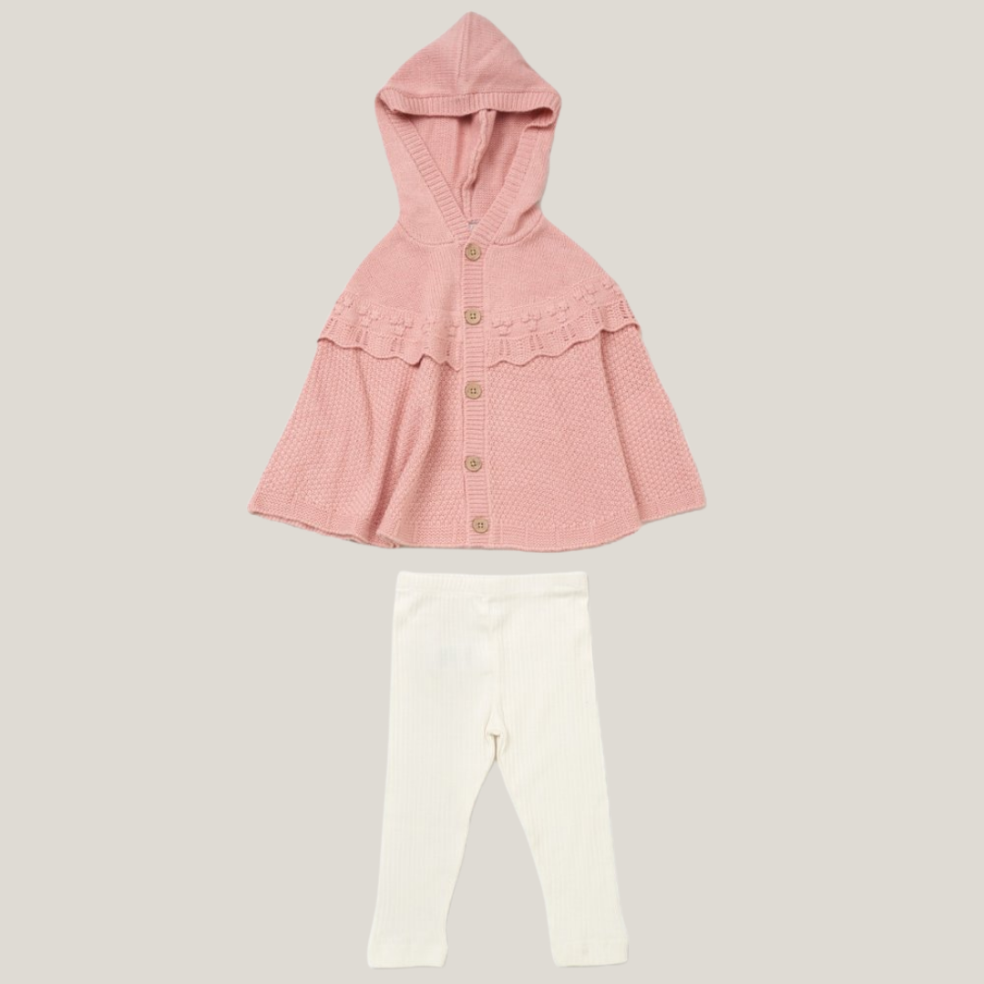 A baby girl's two-piece knit outfit set featuring a light pink hooded cardigan with a ruffled hem and brown buttons, paired with white leggings, shown on a solid light gray background.