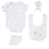 Baby clothing set with onesie, bib, socks, and plush toy on a white background