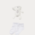 White teddy bear and socks on a light gray background