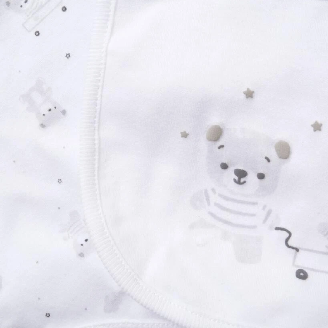 White baby romper with bear design and star patterns on a white background
